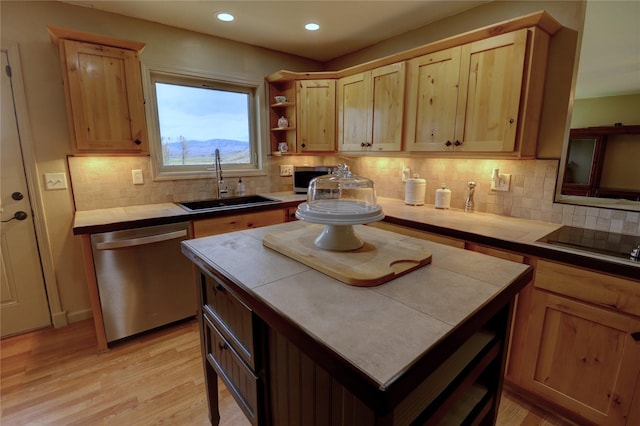 kitchen with sink, tile countertops, light hardwood / wood-style flooring, stainless steel dishwasher, and decorative backsplash