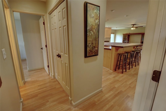 corridor with light hardwood / wood-style flooring