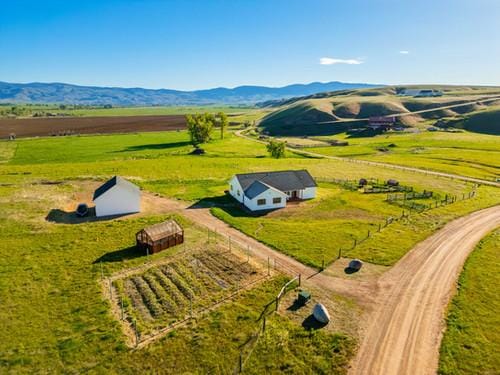 birds eye view of property featuring a mountain view and a rural view