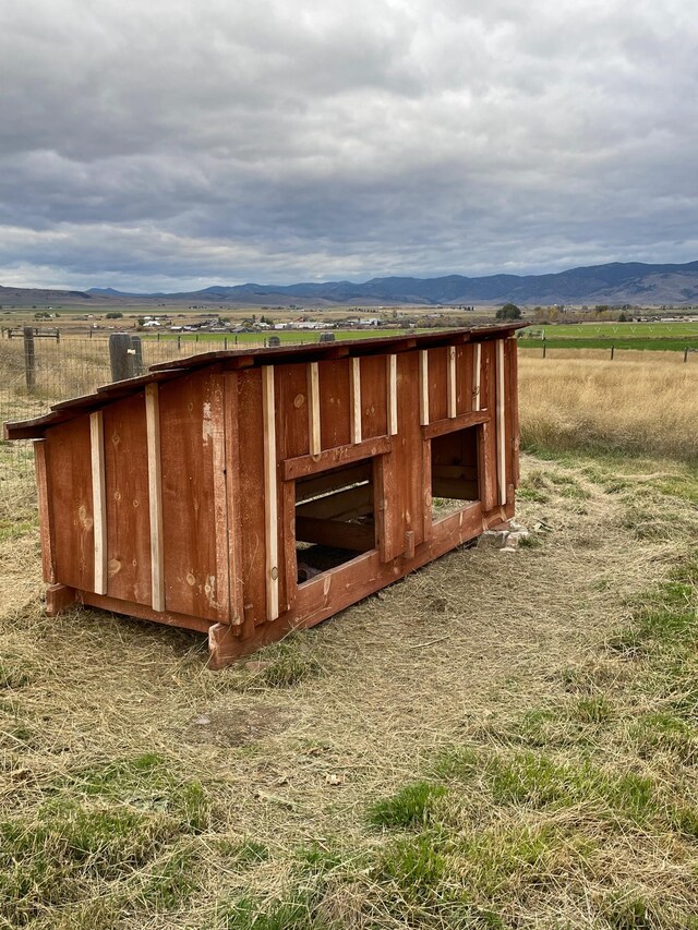 view of outbuilding featuring a mountain view and a rural view