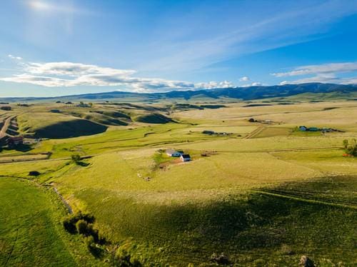 drone / aerial view with a mountain view and a rural view