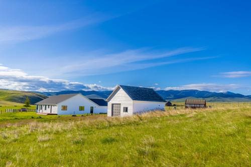 exterior space with a rural view and a mountain view