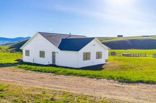 view of home's exterior with a mountain view and a rural view