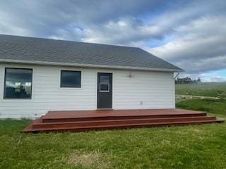 back of house with a lawn