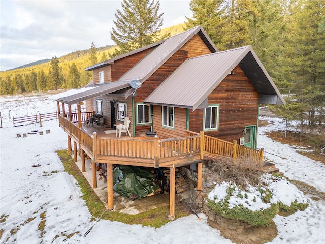 snow covered house with a deck