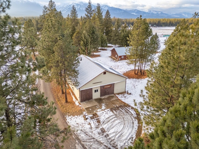 snowy aerial view with a mountain view