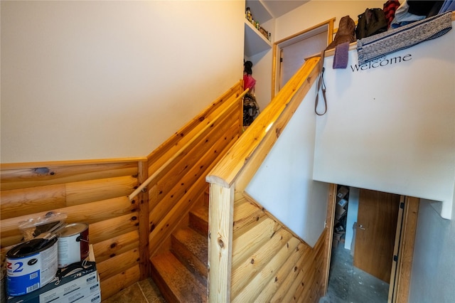 stairway featuring rustic walls