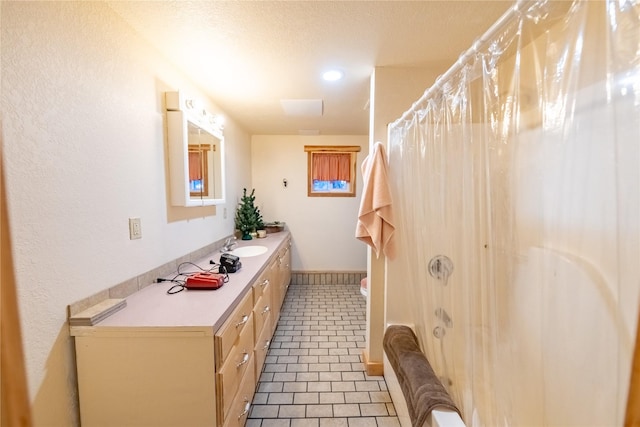 bathroom with a shower with shower curtain, vanity, and tile patterned floors