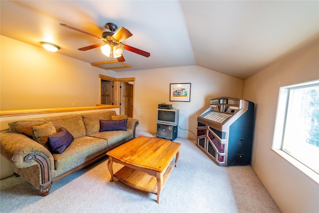 living room featuring ceiling fan, light colored carpet, and vaulted ceiling