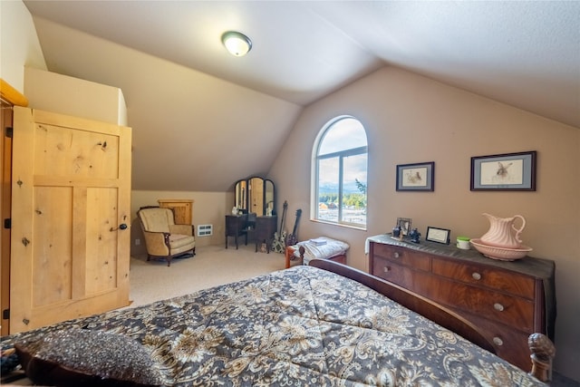 carpeted bedroom with lofted ceiling