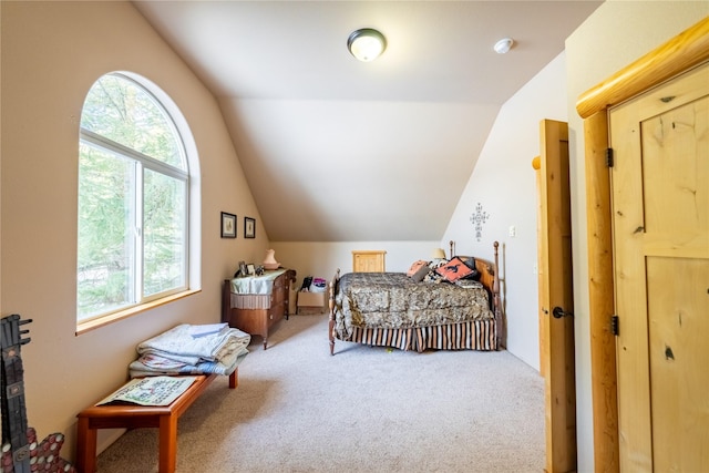 carpeted bedroom with vaulted ceiling