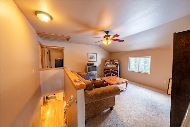 living room featuring carpet flooring, vaulted ceiling, and ceiling fan