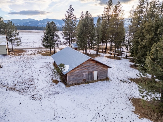 snowy aerial view featuring a mountain view