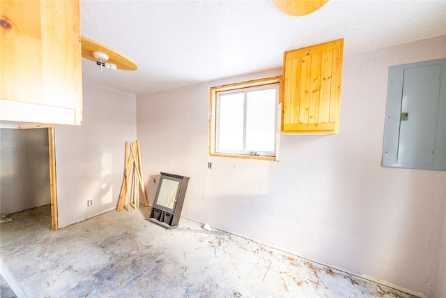 empty room featuring a textured ceiling and electric panel