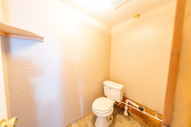 bathroom featuring toilet and a textured ceiling