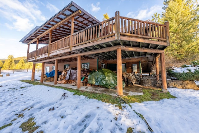 snow covered property featuring a wooden deck