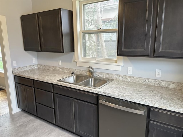 kitchen featuring stainless steel dishwasher, a healthy amount of sunlight, light wood-type flooring, and sink