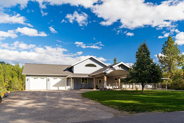 view of front of house featuring a porch, a garage, and a front yard