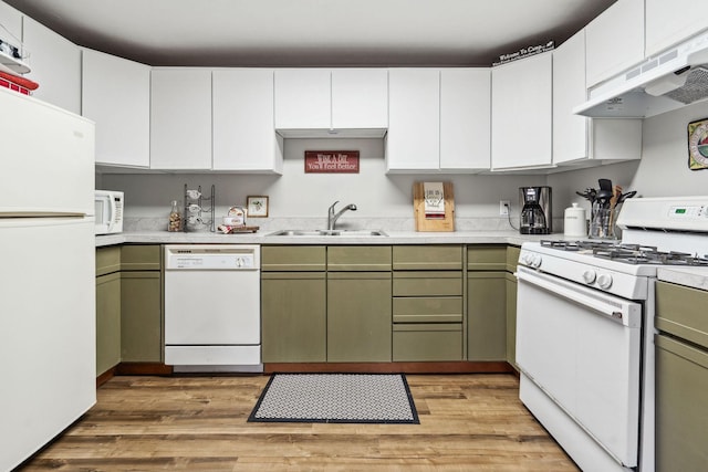 kitchen featuring white appliances, sink, green cabinetry, light wood-type flooring, and extractor fan