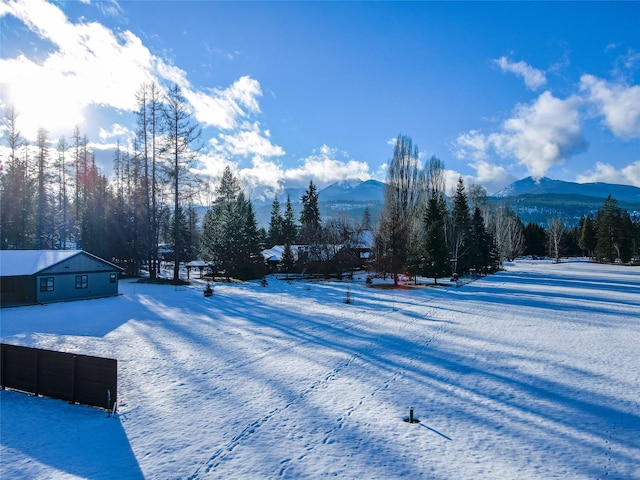 snowy yard featuring a mountain view