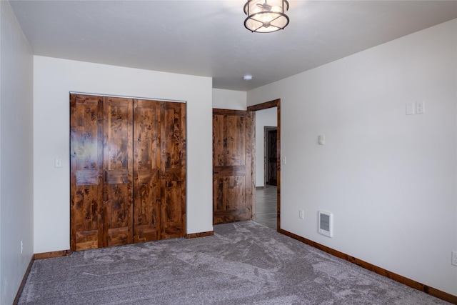 unfurnished bedroom with carpet and a closet