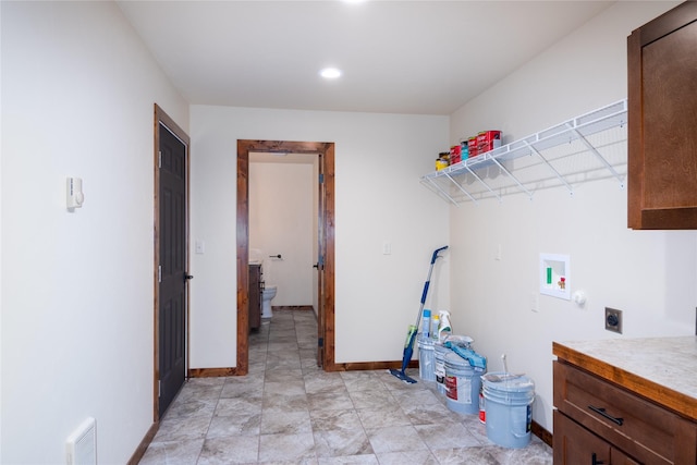 laundry room featuring hookup for an electric dryer, washer hookup, and cabinets