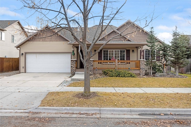 craftsman-style home featuring a front yard, a porch, and a garage