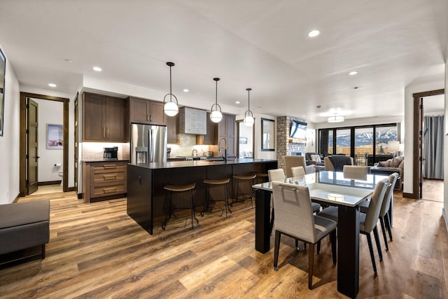 dining room featuring sink and light wood-type flooring