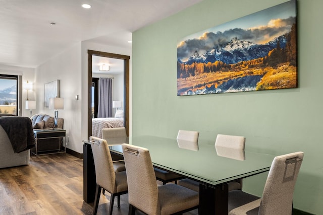 dining space featuring wood finished floors, recessed lighting, and baseboards