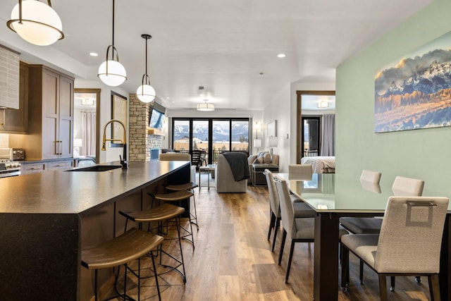 dining space with light wood-type flooring and sink