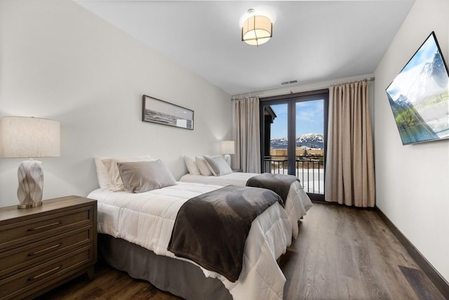 bedroom featuring access to exterior and hardwood / wood-style floors