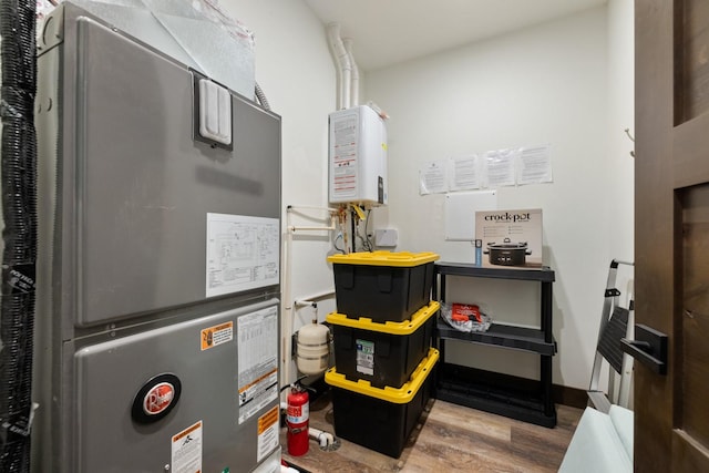 utility room featuring water heater and heating unit