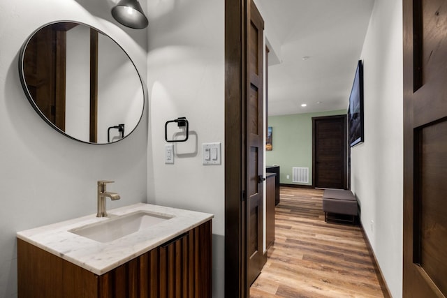 bathroom featuring wood finished floors and vanity