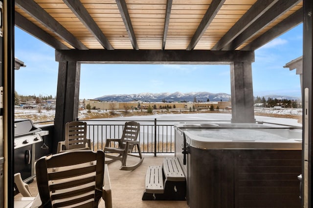 snow covered patio featuring a mountain view