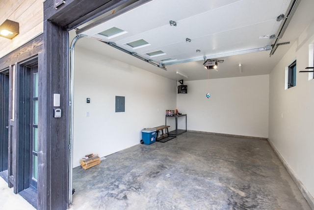 garage with a garage door opener and electric panel