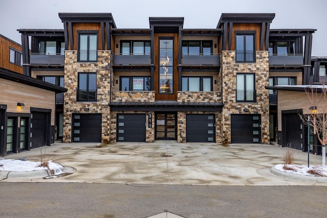 view of building exterior with an attached garage and driveway