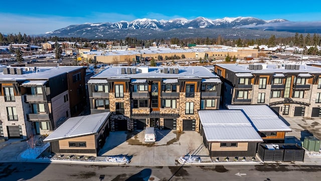 snowy aerial view featuring a mountain view