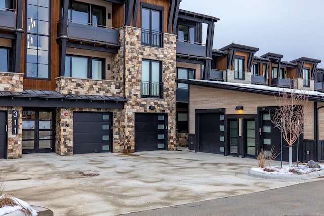 view of property with a garage and driveway