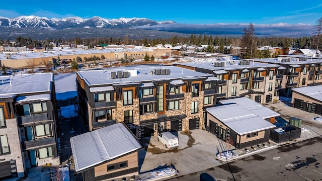 snowy aerial view with a mountain view