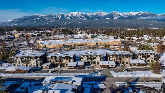 snowy aerial view with a mountain view