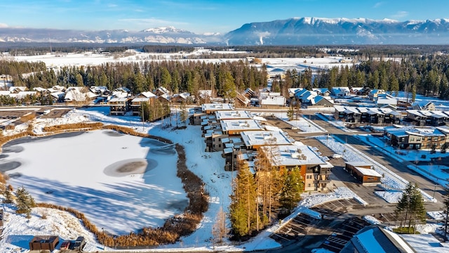 snowy aerial view with a mountain view