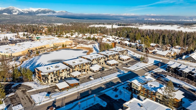 snowy aerial view with a mountain view