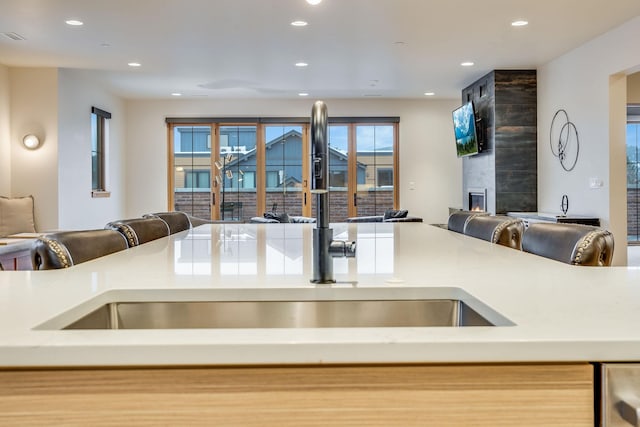 kitchen featuring a tiled fireplace and sink