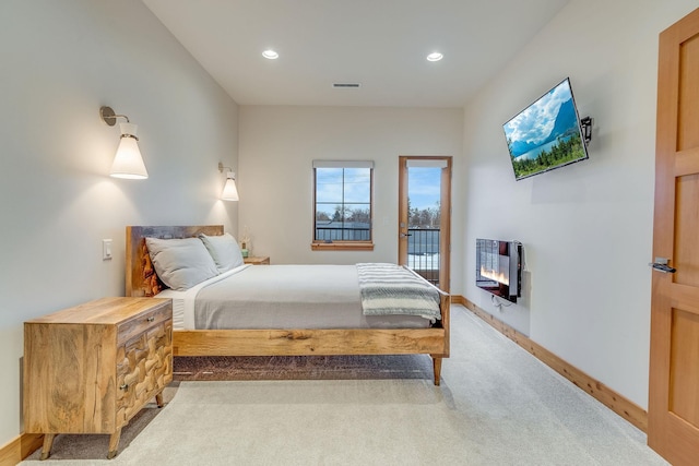 bedroom featuring light carpet and access to exterior