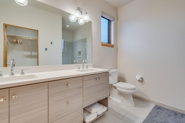 bathroom featuring tile patterned flooring, vanity, toilet, and a shower with shower door