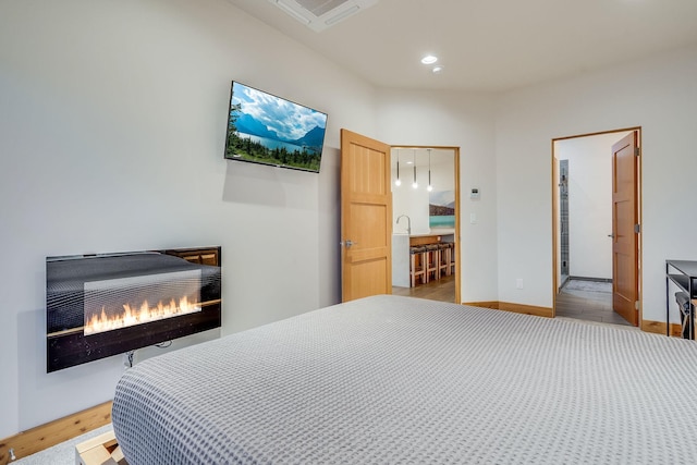 bedroom with a fireplace and heating unit