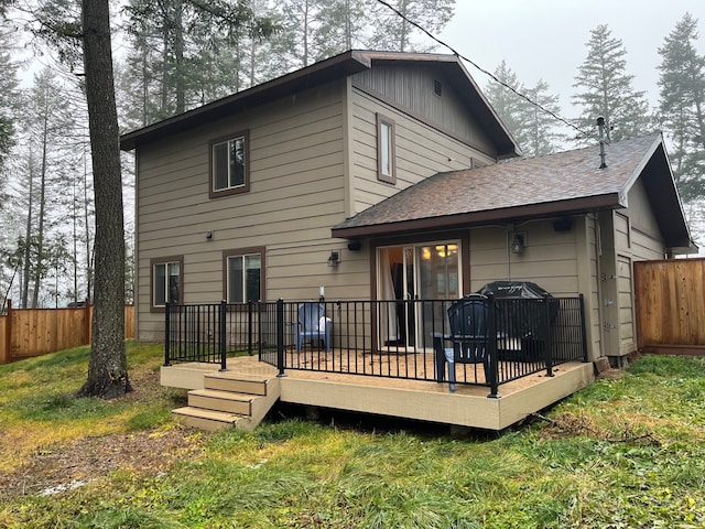 back of house featuring a yard and a deck