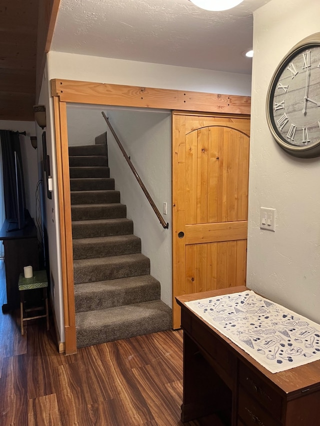 staircase with hardwood / wood-style floors