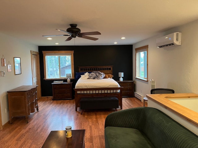 bedroom with an AC wall unit, ceiling fan, dark hardwood / wood-style flooring, and a baseboard heating unit