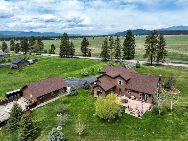 birds eye view of property with a mountain view and a rural view